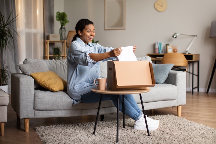 woman unboxing a customized ecommerce apparel order