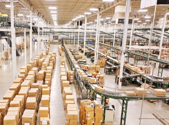 Cart.com warehouse fulfillment center with boxes on conveyor