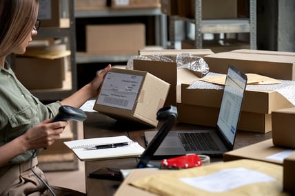female-seller-scanning-ecommerce-shipping-box